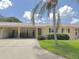 Charming single-story home featuring a carport and mature landscaping at 390 301 W Blvd # 2C, Bradenton, FL 34205