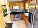 Well-equipped kitchen with stainless steel appliances, tile backsplash, and ample cabinet space at 390 301 W Blvd # 2C, Bradenton, FL 34205