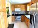 Modern kitchen with stainless steel appliances, tile backsplash, and bright lighting at 390 301 W Blvd # 2C, Bradenton, FL 34205