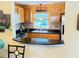 Kitchen with updated counter tops, wooden cabinets, mosaic backsplash, and stainless steel appliances at 390 301 W Blvd # 2C, Bradenton, FL 34205
