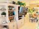 Living room featuring a large entertainment center and an open view to the dining area at 390 301 W Blvd # 2C, Bradenton, FL 34205