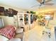 Cozy living room with tile floors, modern ceiling fan, and an open view to the dining area and kitchen at 390 301 W Blvd # 2C, Bradenton, FL 34205