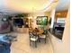 Well-lit living area with dining table and chairs and view of the kitchen with a breakfast bar at 390 301 W Blvd # 2C, Bradenton, FL 34205