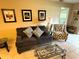Inviting living room with sofa, accent chair, decorative pillows, and framed artwork at 390 301 W Blvd # 2C, Bradenton, FL 34205
