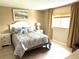 Comfortable bedroom with serene decor, tile floors, and abundant natural light at 390 301 W Blvd # 2C, Bradenton, FL 34205