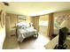Comfortable bedroom with serene decor, tile floors, and abundant natural light at 390 301 W Blvd # 2C, Bradenton, FL 34205