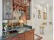 Elegant bar area featuring custom cabinetry, granite countertop, and mirrored backsplash with glass rack at 4224 Boca Pointe Dr, Sarasota, FL 34238