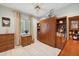 Cozy bedroom featuring a Murphy bed, wood-look floors and a ceiling fan at 4224 Boca Pointe Dr, Sarasota, FL 34238