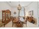 Formal dining room featuring wood furniture, chandelier, and elegant wallpaper at 4224 Boca Pointe Dr, Sarasota, FL 34238