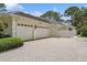 Spacious two-car garage with an extended brick paved driveway, perfect for extra parking at 4224 Boca Pointe Dr, Sarasota, FL 34238
