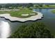 Aerial view of a golf course featuring manicured greens, sand traps, and a serene lake at 4224 Boca Pointe Dr, Sarasota, FL 34238