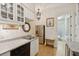 Galley kitchen featuring white cabinets, granite counters, and stainless steel appliances at 4224 Boca Pointe Dr, Sarasota, FL 34238