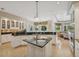 Bright, open kitchen with granite countertops, island, and views of the outdoor living area at 4224 Boca Pointe Dr, Sarasota, FL 34238