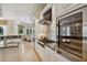 Gourmet kitchen with stainless steel appliances, built-in wine cooler, and granite countertops at 4224 Boca Pointe Dr, Sarasota, FL 34238