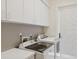 Bright laundry room with white cabinets and modern washer and dryer at 4224 Boca Pointe Dr, Sarasota, FL 34238