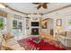 Beautiful living room with fireplace, custom built-ins, and access to outdoor patio at 4224 Boca Pointe Dr, Sarasota, FL 34238