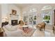 Cozy living room with marble floors, fireplace, and views of the backyard at 4224 Boca Pointe Dr, Sarasota, FL 34238
