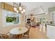 Cozy living room with dining area featuring a chandelier and views of the backyard at 4224 Boca Pointe Dr, Sarasota, FL 34238