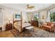Traditional main bedroom with a four-poster bed, sitting area, and light-filled windows at 4224 Boca Pointe Dr, Sarasota, FL 34238