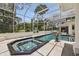 Spectacular pool area with an attached spa and a screened enclosure at 4224 Boca Pointe Dr, Sarasota, FL 34238