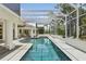 Gorgeous screened-in pool and spa area surrounded by lush landscaping at 4224 Boca Pointe Dr, Sarasota, FL 34238