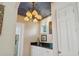 This wet bar features a unique ceiling fixture, storage, and a beautiful black granite countertop at 4224 Boca Pointe Dr, Sarasota, FL 34238