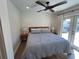 Serene bedroom with a comfortable bed, stylish lamps, and access to the backyard at 4460 Emerald Ridge Dr, Sarasota, FL 34233