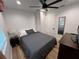 Cozy bedroom boasts a ceiling fan, wood floors, and natural light from the window at 4460 Emerald Ridge Dr, Sarasota, FL 34233