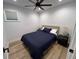Comfortable bedroom boasts a ceiling fan, wood floors, and natural light from the window at 4460 Emerald Ridge Dr, Sarasota, FL 34233