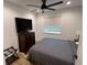 Bedroom with a dresser, ceiling fan and natural light coming from the window at 4460 Emerald Ridge Dr, Sarasota, FL 34233