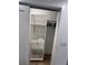 Organized closet with wooden shelving, drawers, and hanging rods offers efficient storage solutions at 4460 Emerald Ridge Dr, Sarasota, FL 34233