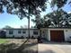 Charming single-story home with a well-manicured lawn, attached garage and crisp white siding at 4460 Emerald Ridge Dr, Sarasota, FL 34233