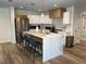 Modern kitchen featuring an island with a marble countertop, stainless steel appliances, and pendant lighting at 4460 Emerald Ridge Dr, Sarasota, FL 34233