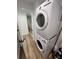 Efficient laundry area features stacked washer and dryer units maximizing space at 4460 Emerald Ridge Dr, Sarasota, FL 34233