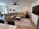 Inviting living room featuring a neutral sectional sofa, stylish rug, and modern ceiling fan at 4460 Emerald Ridge Dr, Sarasota, FL 34233