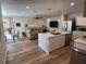 Open-concept living space with a kitchen island, dining table, and comfortable seating area at 4460 Emerald Ridge Dr, Sarasota, FL 34233