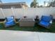 Cozy outdoor seating area with comfortable chairs and a stylish fire pit table at 4460 Emerald Ridge Dr, Sarasota, FL 34233