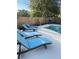 Relaxing pool area featuring lounge chairs, pool, grill, and privacy fence at 4460 Emerald Ridge Dr, Sarasota, FL 34233