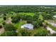 Areal view showcasing a beautiful property surrounded by lush trees and large lawn at 4513 Hidden River Rd, Sarasota, FL 34240