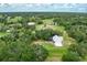 Aerial view of a beautiful home surrounded by lush green trees at 4513 Hidden River Rd, Sarasota, FL 34240