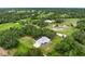 Aerial view of a beautiful home surrounded by lush green trees at 4513 Hidden River Rd, Sarasota, FL 34240
