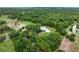 Aerial view of a beautiful home surrounded by lush green trees at 4513 Hidden River Rd, Sarasota, FL 34240