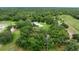 Aerial view of a beautiful home surrounded by lush green trees at 4513 Hidden River Rd, Sarasota, FL 34240
