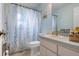 Bathroom with a vanity, shower, and colorful floral shower curtain at 4513 Hidden River Rd, Sarasota, FL 34240