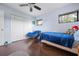 This bedroom features a bed, chair, a closet and windows at 4513 Hidden River Rd, Sarasota, FL 34240