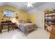 Bedroom with yellow walls, decor, and natural light at 4513 Hidden River Rd, Sarasota, FL 34240