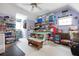 Spacious bonus room with ample storage, work tables, and natural light at 4513 Hidden River Rd, Sarasota, FL 34240