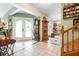 Spacious entryway with elegant double doors, tile flooring, and an antique grandfather clock exudes charm and sophistication at 4513 Hidden River Rd, Sarasota, FL 34240