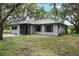 Well-maintained home exterior with a manicured lawn and mature landscaping at 4513 Hidden River Rd, Sarasota, FL 34240
