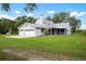 Charming single Gathering home showcasing a screened in porch and a two car garage on a sunny day at 4513 Hidden River Rd, Sarasota, FL 34240